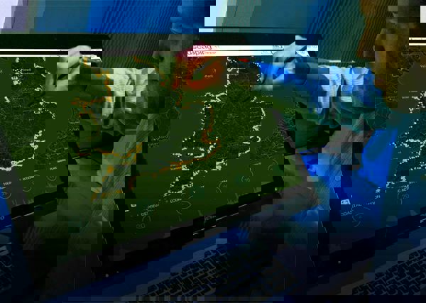 Man using a screen to view assets around the UK