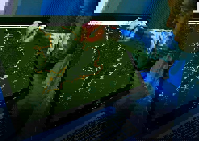 Man using a screen to view assets around the UK