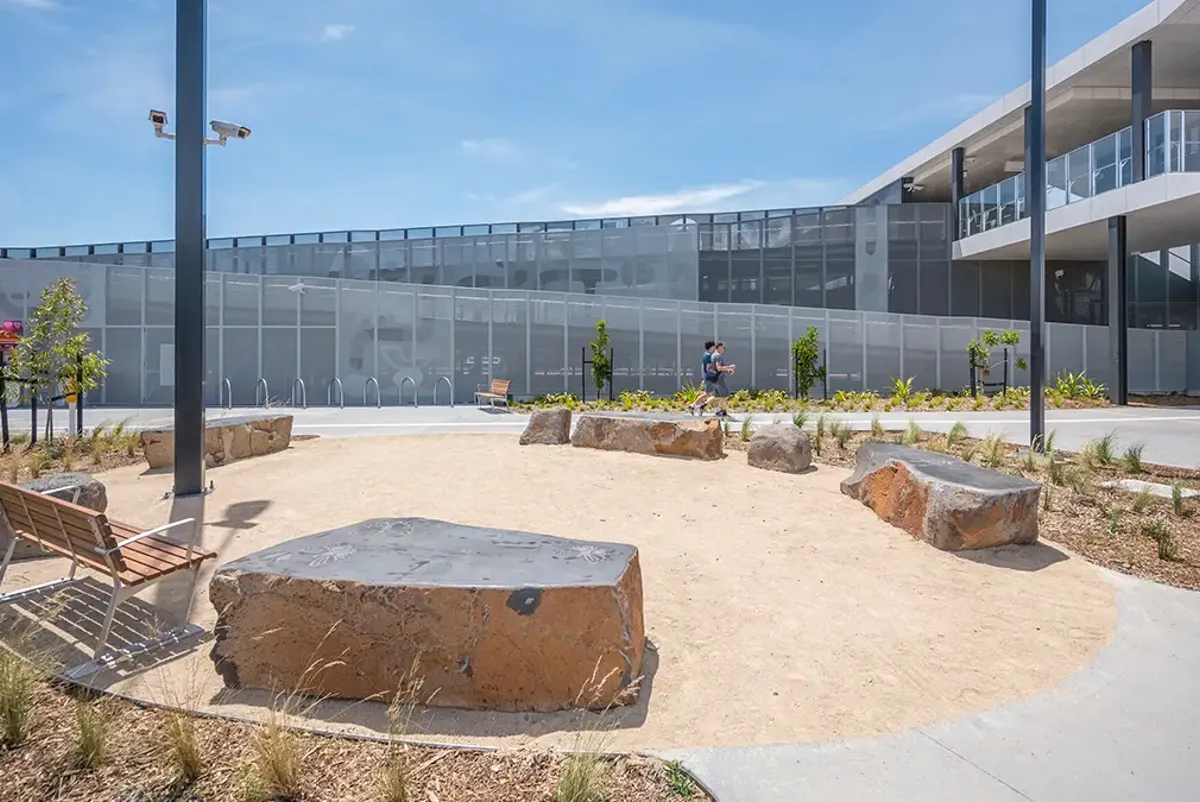 A circle of stone benches and seating with plants and trees