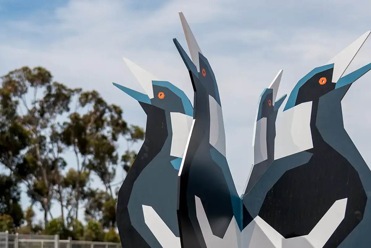 metal sculpture of large styilised black and white birds