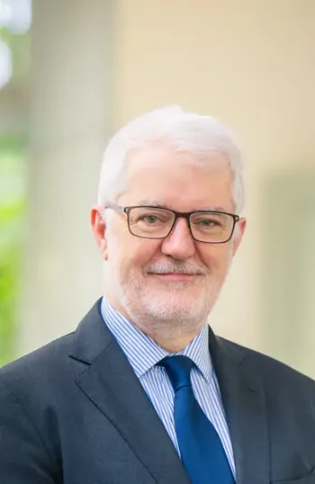 A man wearing glasses and a suit.