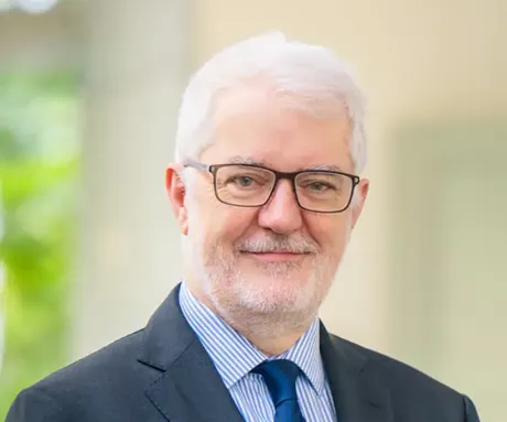 A man wearing glasses and a suit.